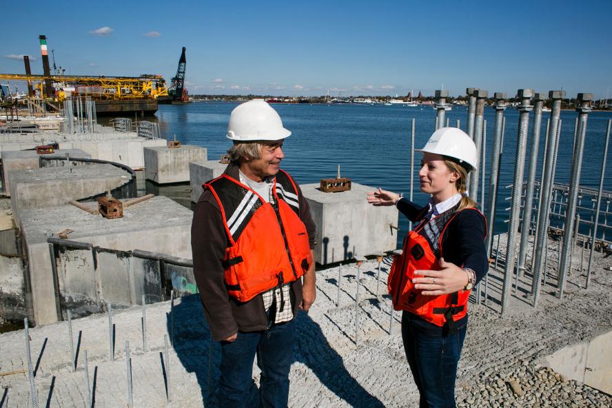Two people standing and talking at New Bedford Marine Commerce Terminal